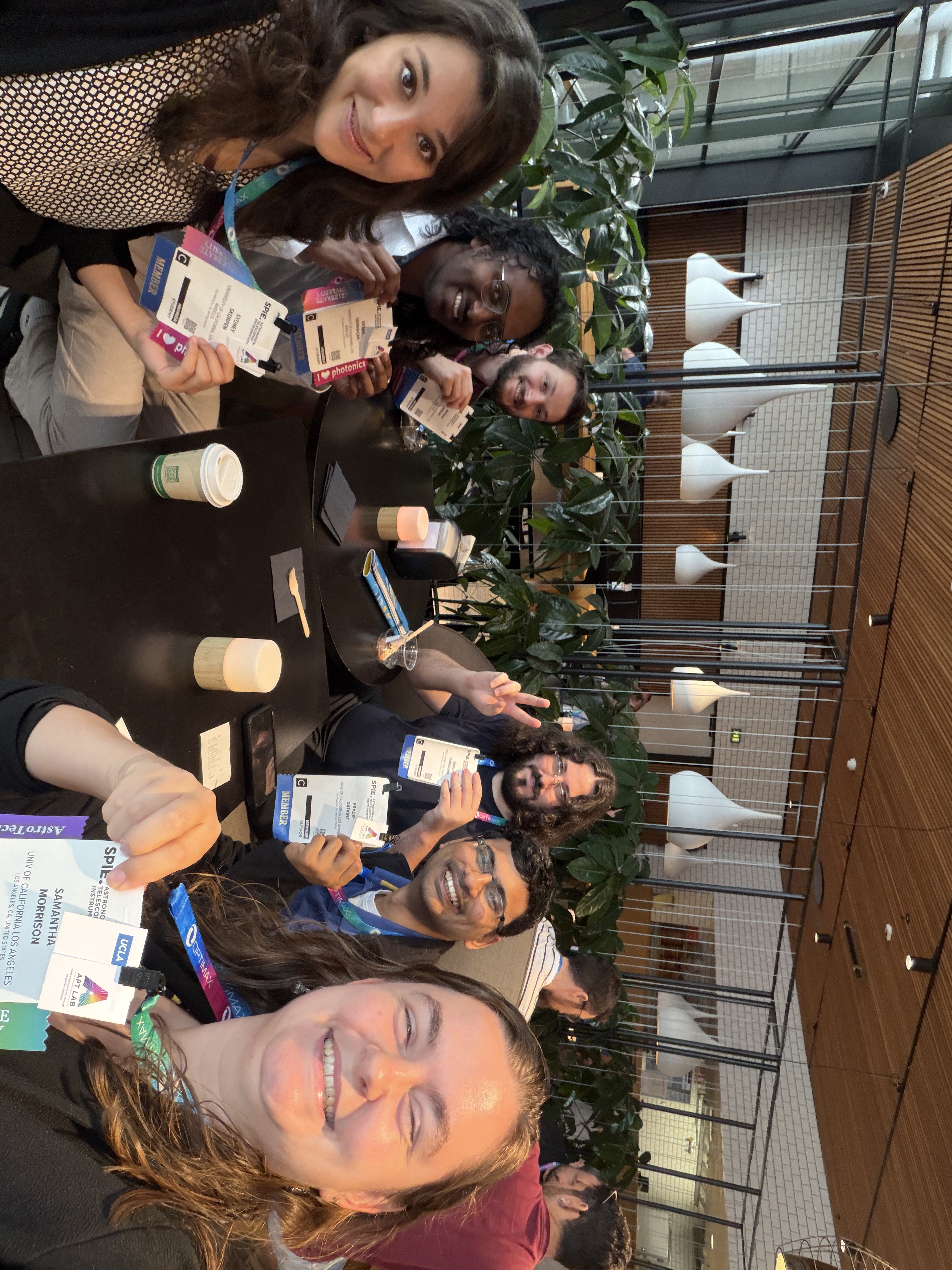 APT Lab hoding up badges at SPIE